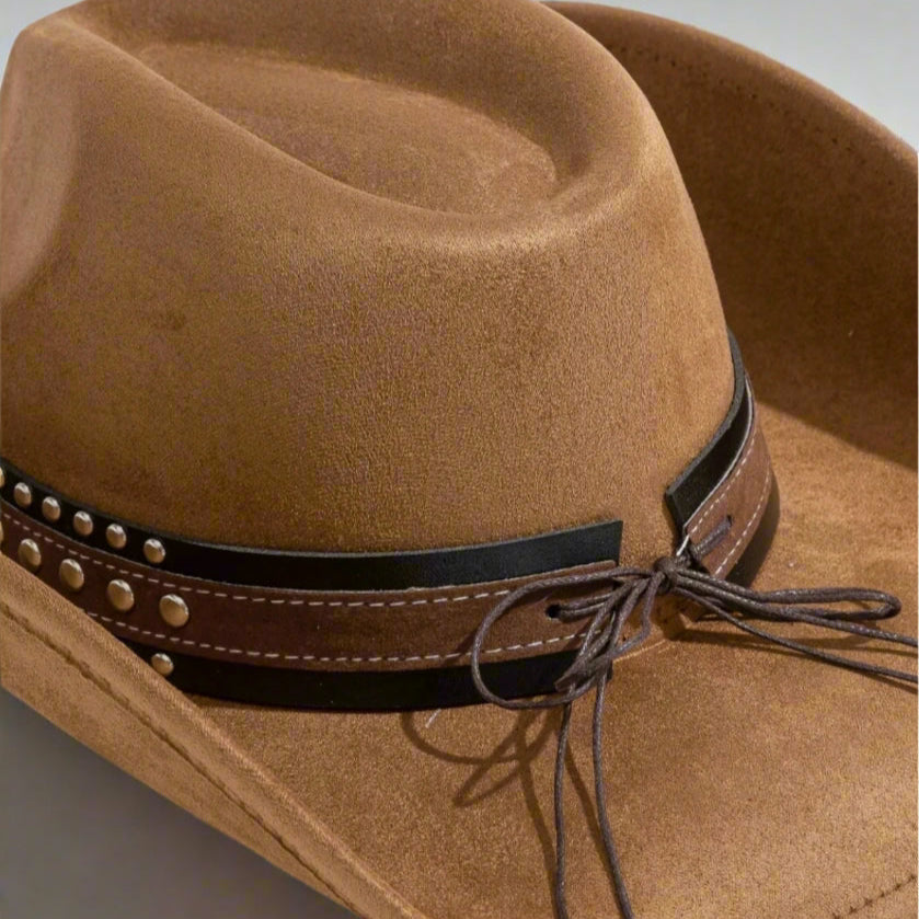 Brown cowboy hat with a decorative band on a light gray background