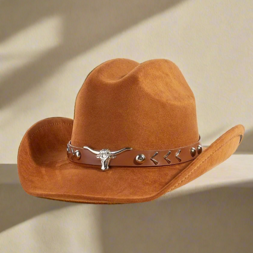 Brown cowboy hat with a decorative band featuring a bull head on a white background