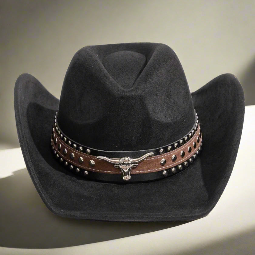 Black cowboy hat with a brown studded band on a neutral background