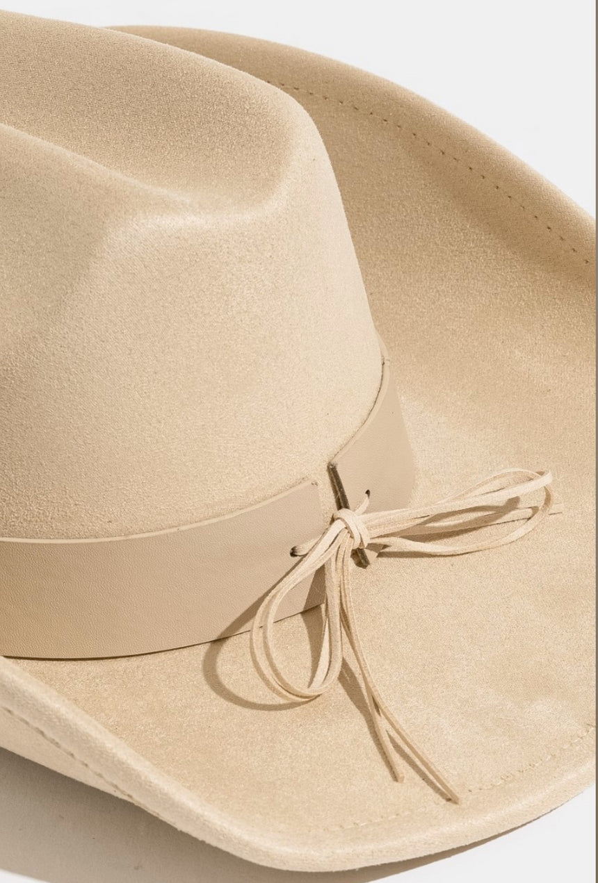 Beige hat with a ribbon on a white background