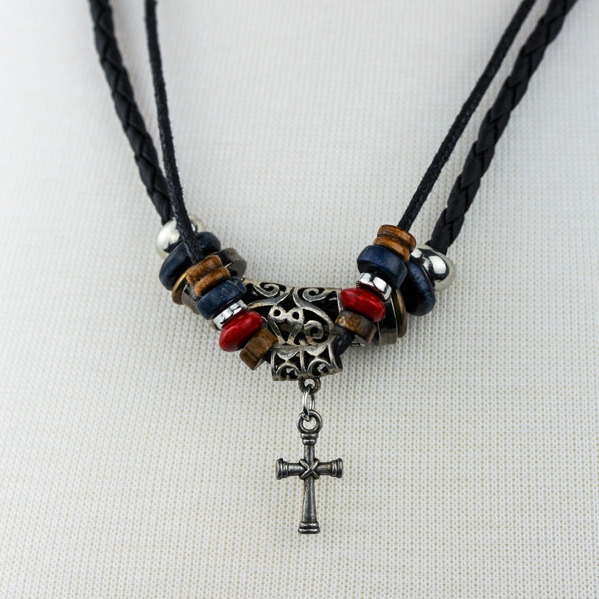Braided Black Cord Choker — Disc Beads, Cross Dangle, bright close-up of the carved barrel bead and hanging cross