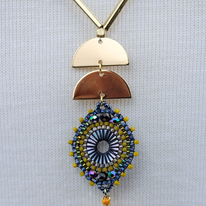Half-Moon Medallion Necklace — Gold-Tone Alloy, Two Colors, Orange colorway, close-up of half-moon discs and medallion