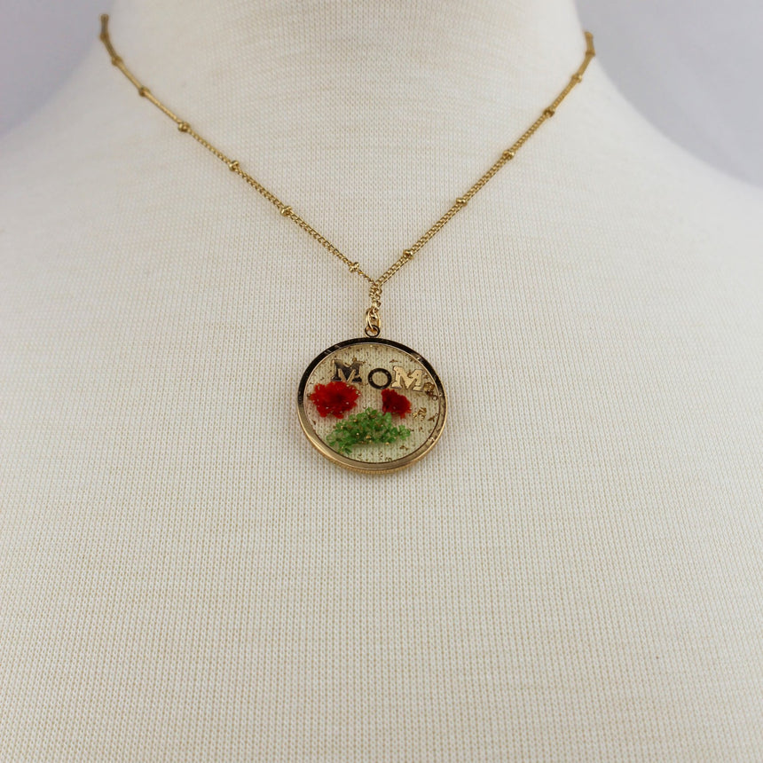 Pressed Flower Mom Pendant — Resin Disc, Gold-Tone Beaded Chain, pendant and beaded chain worn on a mannequin