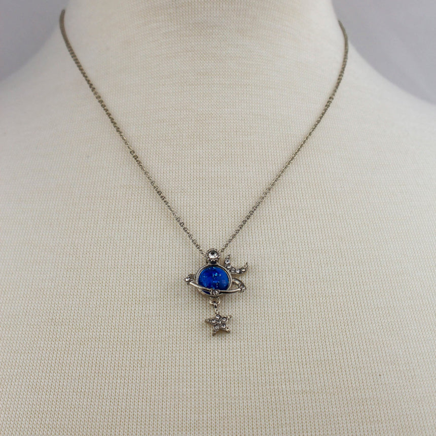 Saturn Pendant Necklace — Silver-Tone Alloy, Star Dangle, full view of the necklace on a mannequin