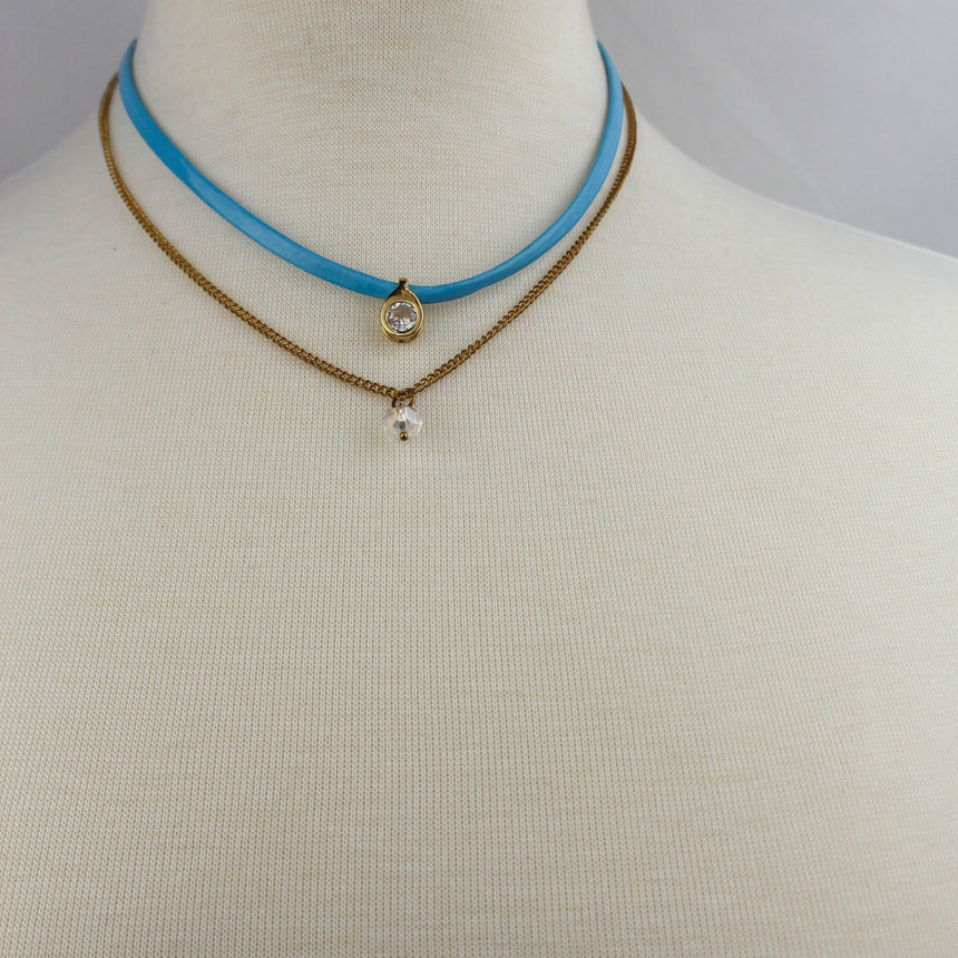 Blue Suede Choker Set — Gold-Tone Chain, Matching Stud Earrings, both layers worn on a mannequin