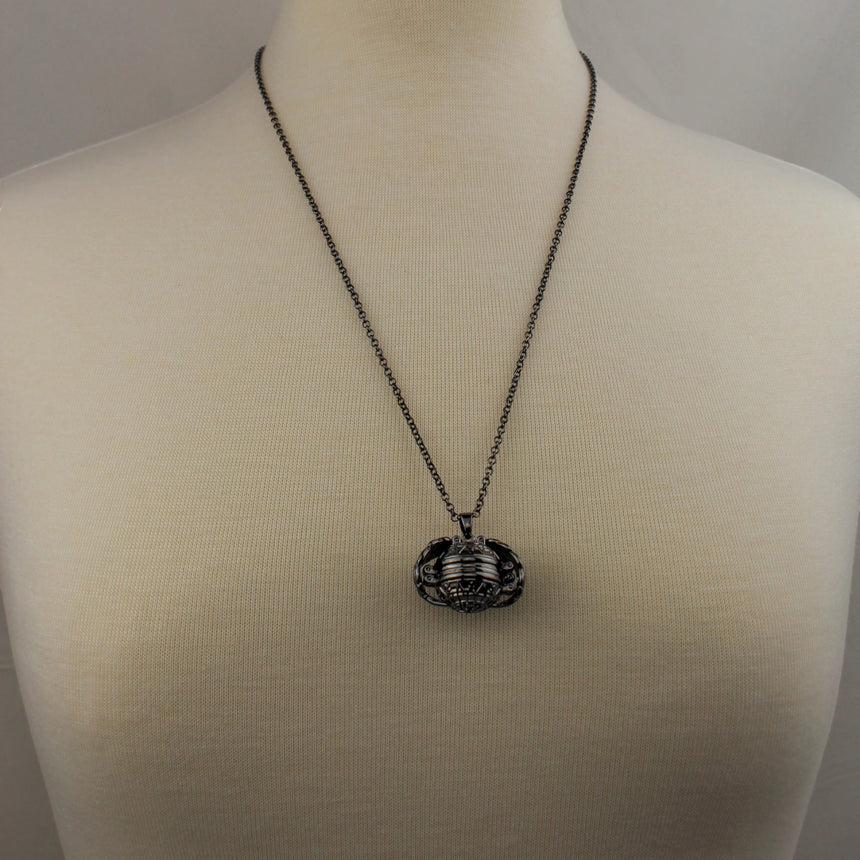 Expanding Photo Ball Locket — Gunmetal or Rose Gold Tone Alloy, gunmetal finish closed, worn on a mannequin