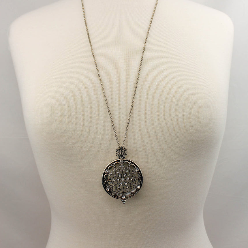Snowflake Filigree Locket — Gunmetal-Tone Alloy, Magnifier, full necklace with long chain on mannequin