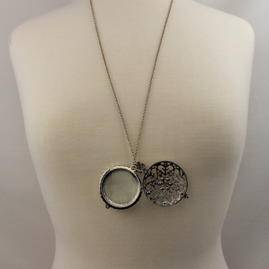 Snowflake Filigree Locket — Gunmetal-Tone Alloy, Magnifier, locket swung open showing the magnifying lens