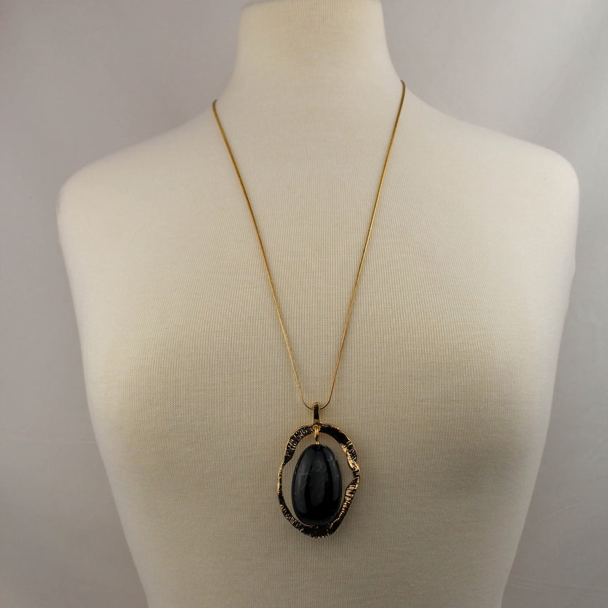 Marbled Cabochon Pendant — Hammered Gold-Tone Oval, Long Chain, worn long on a mannequin