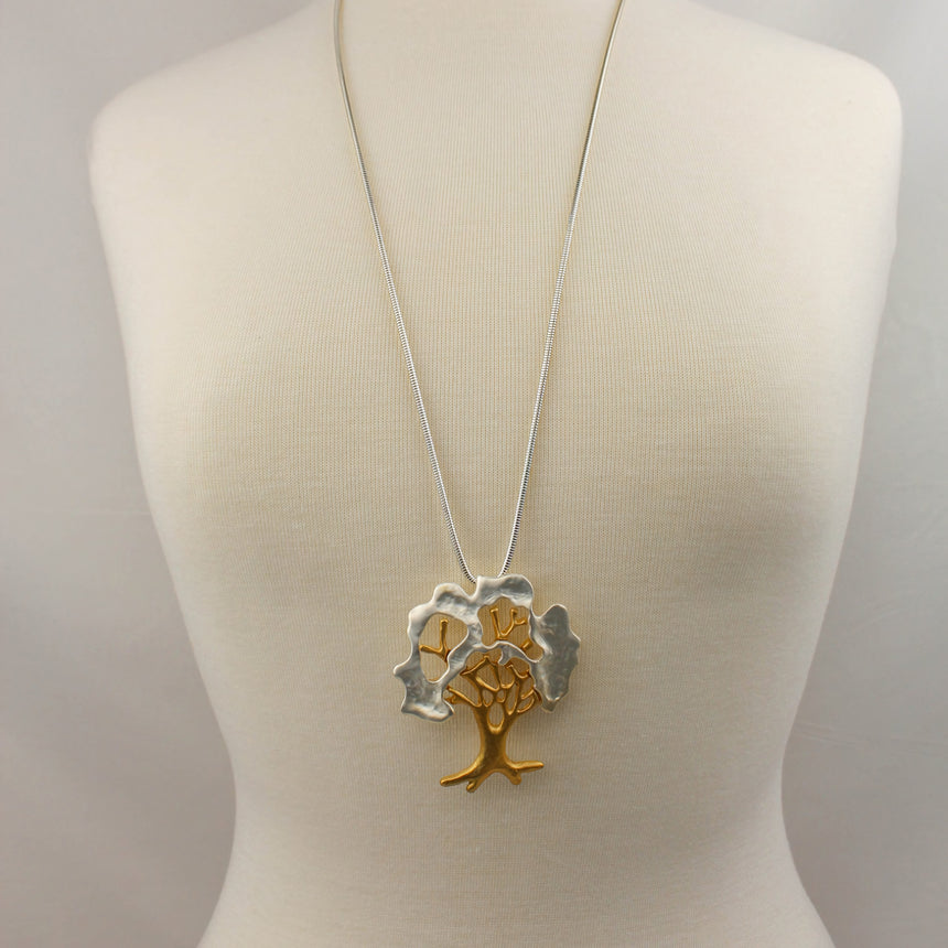 Two-Tone Tree Pendant — Matte Gold and Silver-Tone Alloy, worn long on a mannequin
