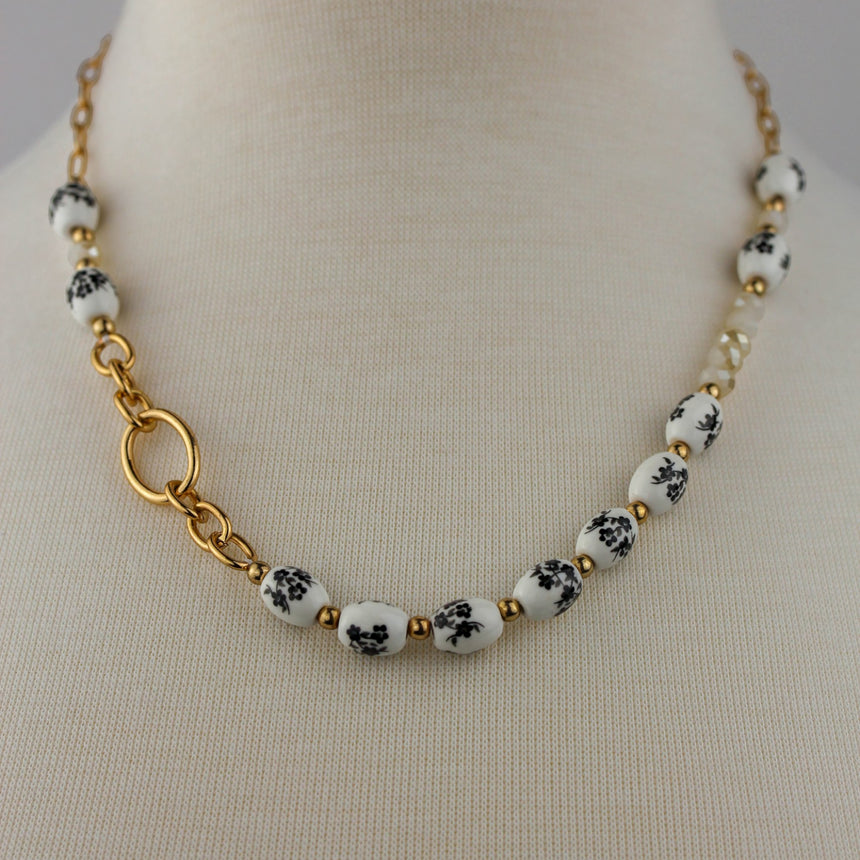 Porcelain Bead Necklace — Floral Print, Gold-Tone Ring, front view of floral beads and ring accent