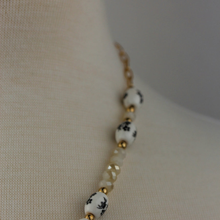 Porcelain Bead Necklace — Floral Print, Gold-Tone Ring, angled side view of the printed beads
