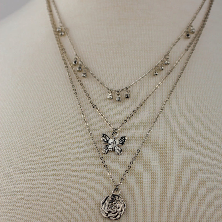 Triple Layer Butterfly Necklace — Gold-Tone or Silver-Tone Alloy, silver finish close-up of butterfly and rose layers