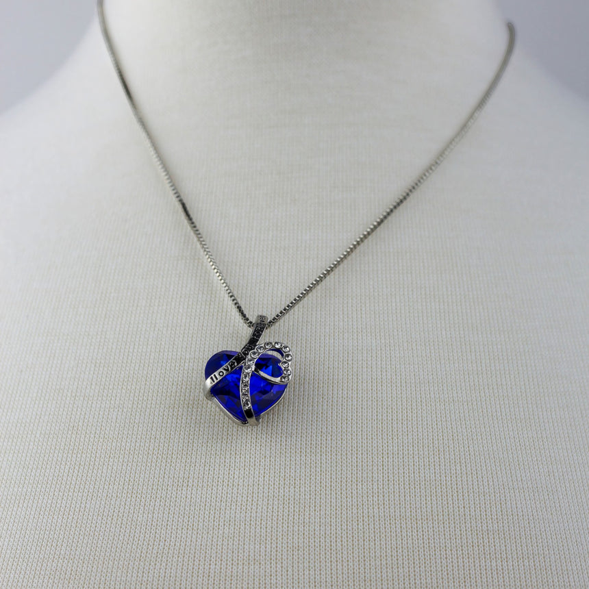 Blue Crystal Heart Necklace — I Love You Ribbon, Silver-Tone, angled view showing the engraved message banner
