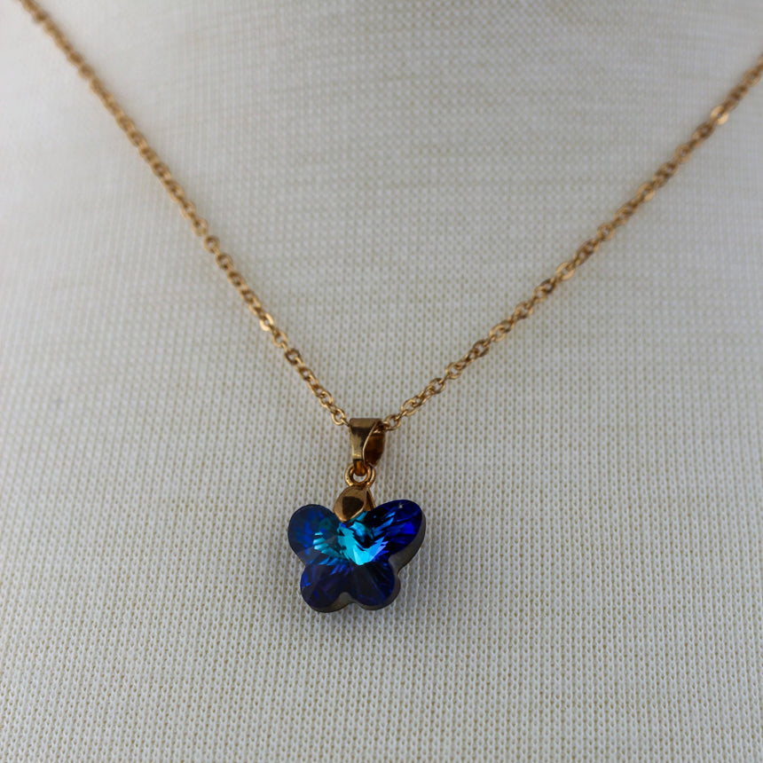 Crystal Butterfly Pendant Necklace — Glass, Four Colorways, Bermuda Blue colorway, pendant view at the collar
