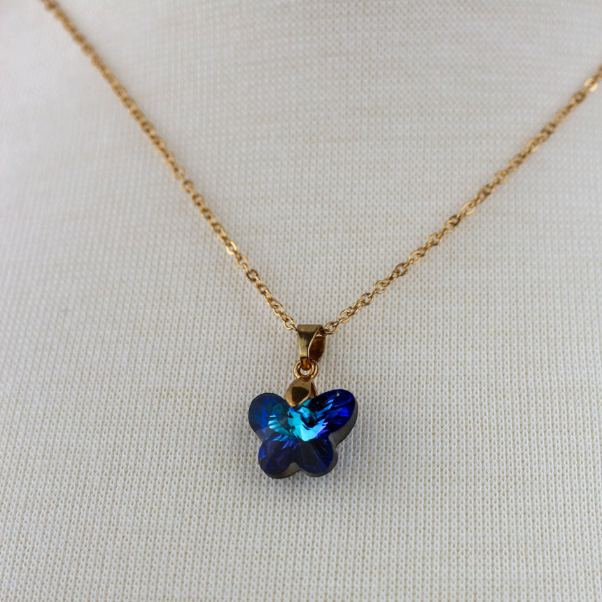 Crystal Butterfly Pendant Necklace — Glass, Four Colorways, Bermuda Blue colorway, close-up of the blue crystal butterfly