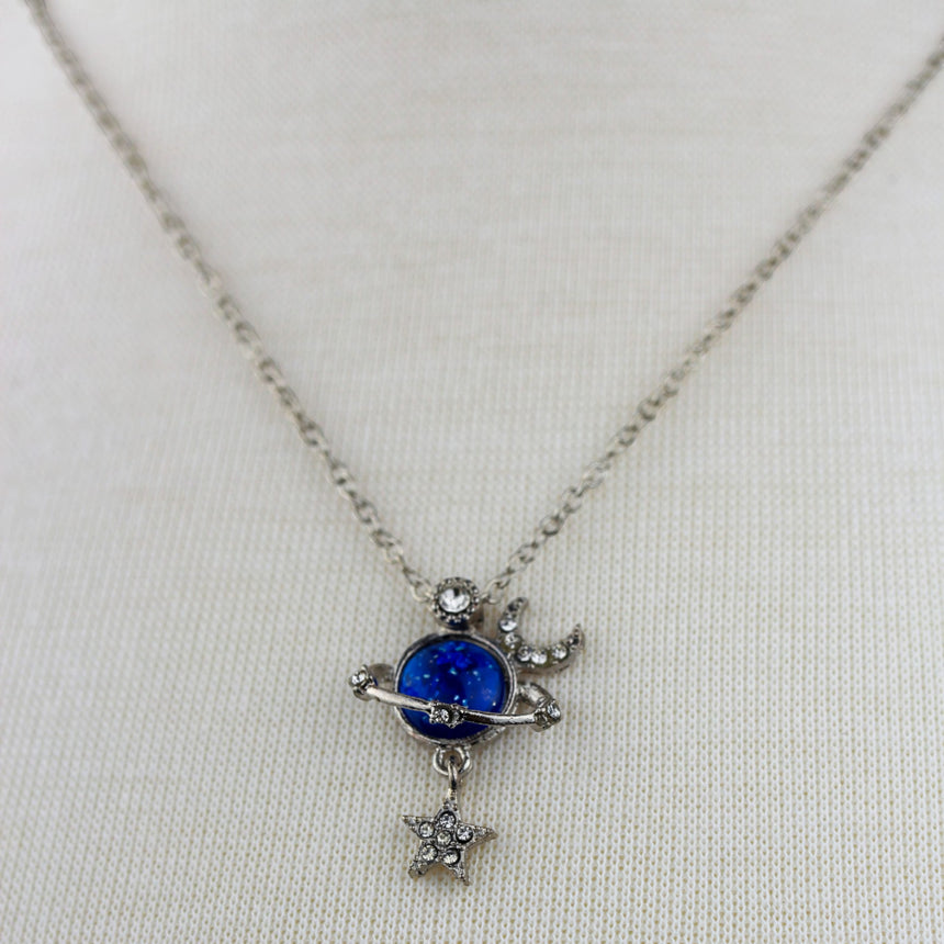 Saturn Pendant Necklace — Silver-Tone Alloy, Star Dangle, close-up of the blue planet pendant with star dangle