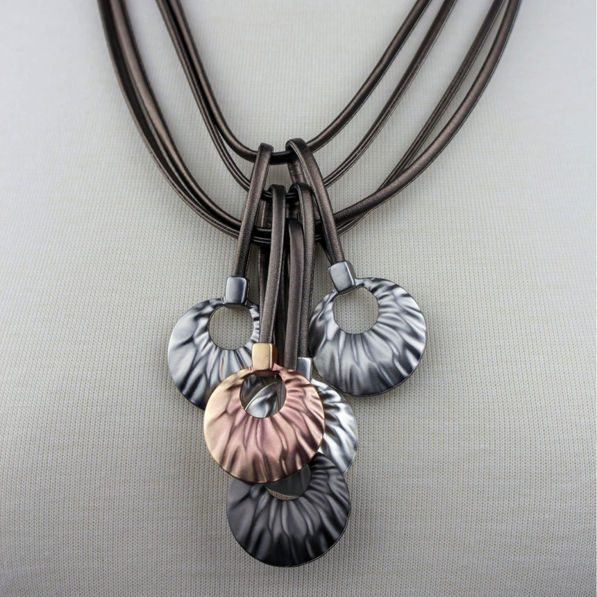 Multi-Cord Statement Necklace — Textured Discs, Mixed Tones, close view of the wavy disc cascade