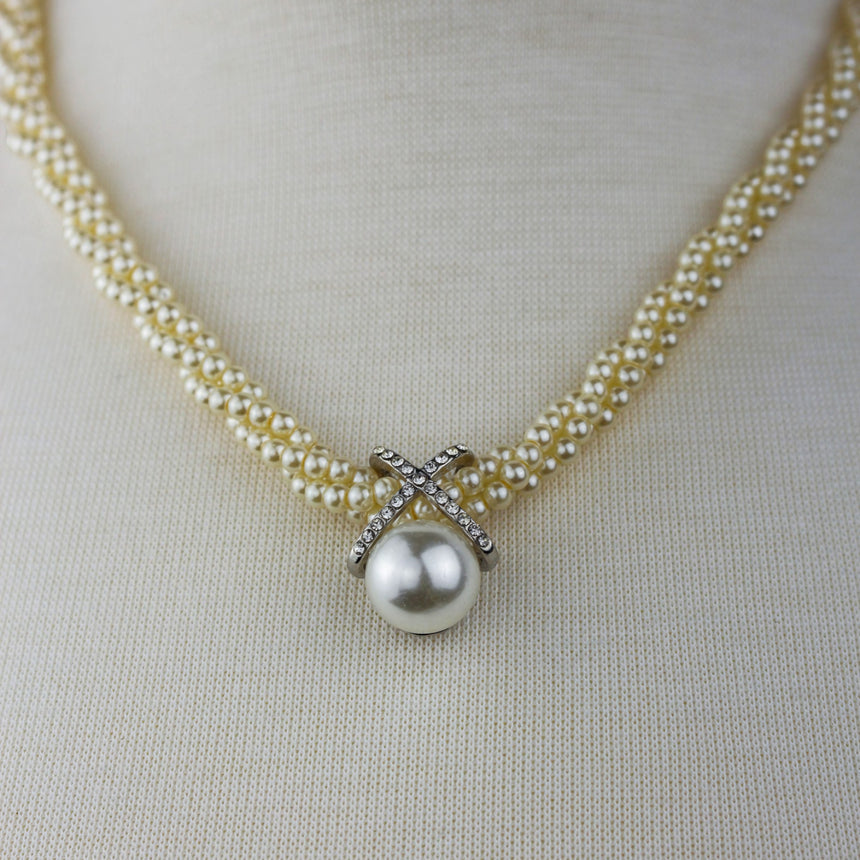 Twisted Pearl Torsade Choker — Faux Seed Pearls, Crystal X Motif, close-up of the crystal X and large pearl