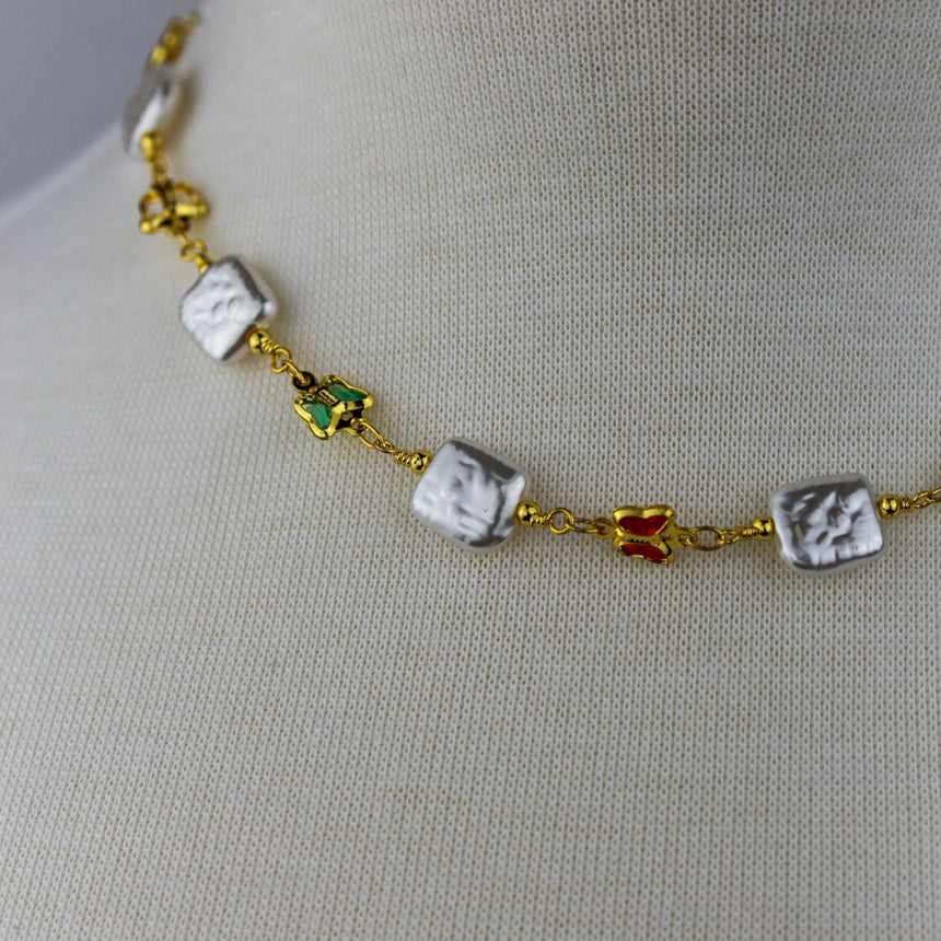 Pearl-Tile Butterfly Choker — Gold-Tone Alloy, Stations, angled close-up of square tiles and a green butterfly