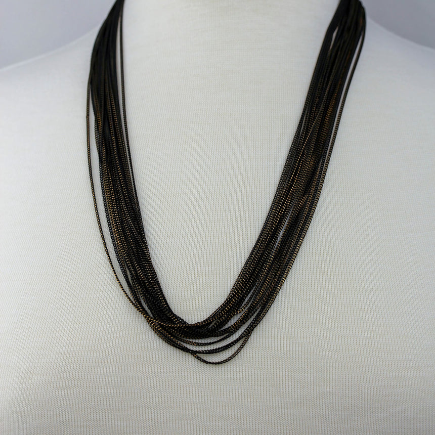 Multi-Strand Chain Necklace — Two-Tone Alloy, Draped Layers, front view of the layered chains