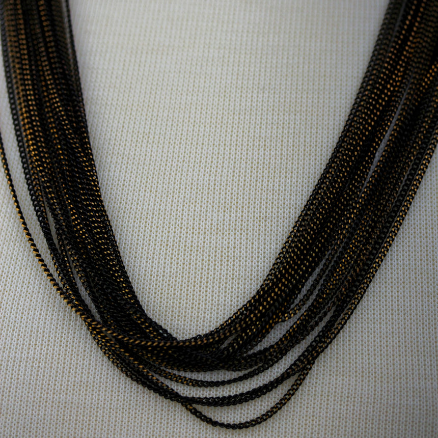 Multi-Strand Chain Necklace — Two-Tone Alloy, Draped Layers, close-up of the two-tone chain texture