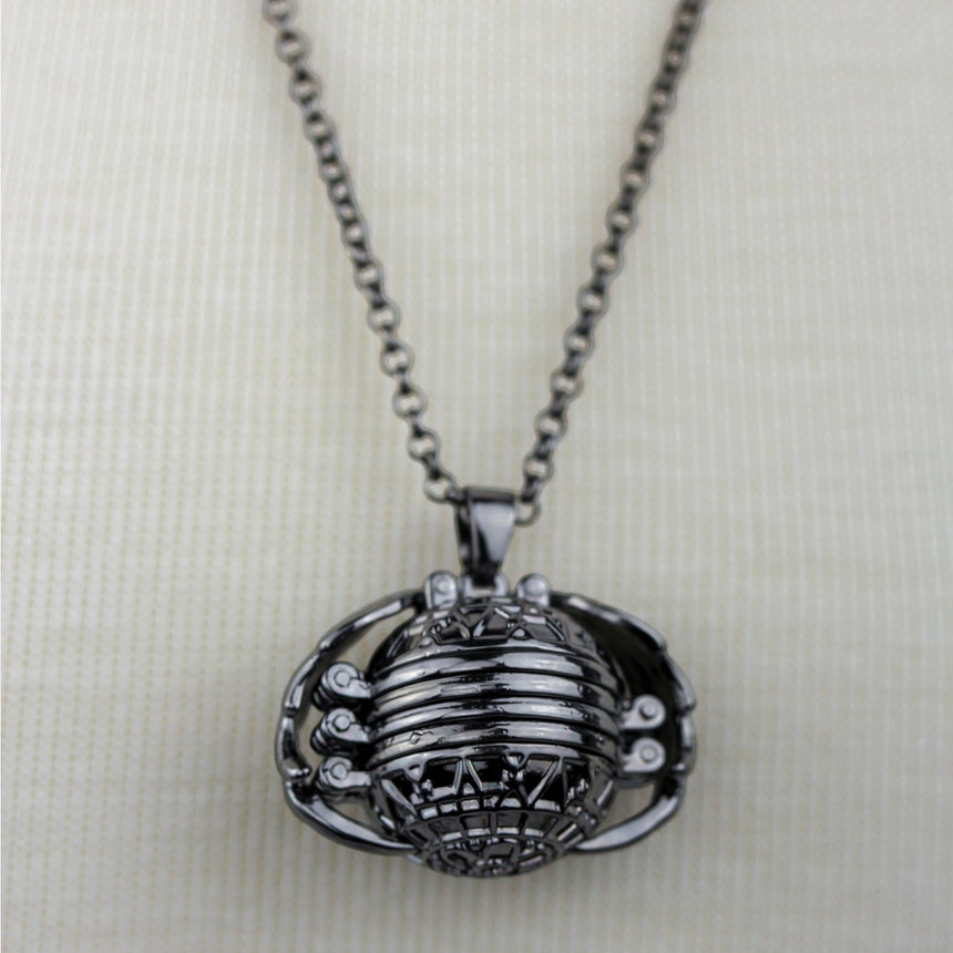 Expanding Photo Ball Locket — Gunmetal or Rose Gold Tone Alloy, gunmetal finish detail of the ribbed ball and wings