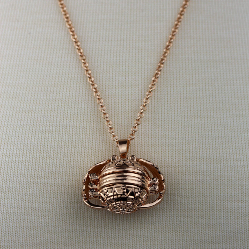 Expanding Photo Ball Locket — Gunmetal or Rose Gold Tone Alloy, rose gold finish close-up of the ribbed ball