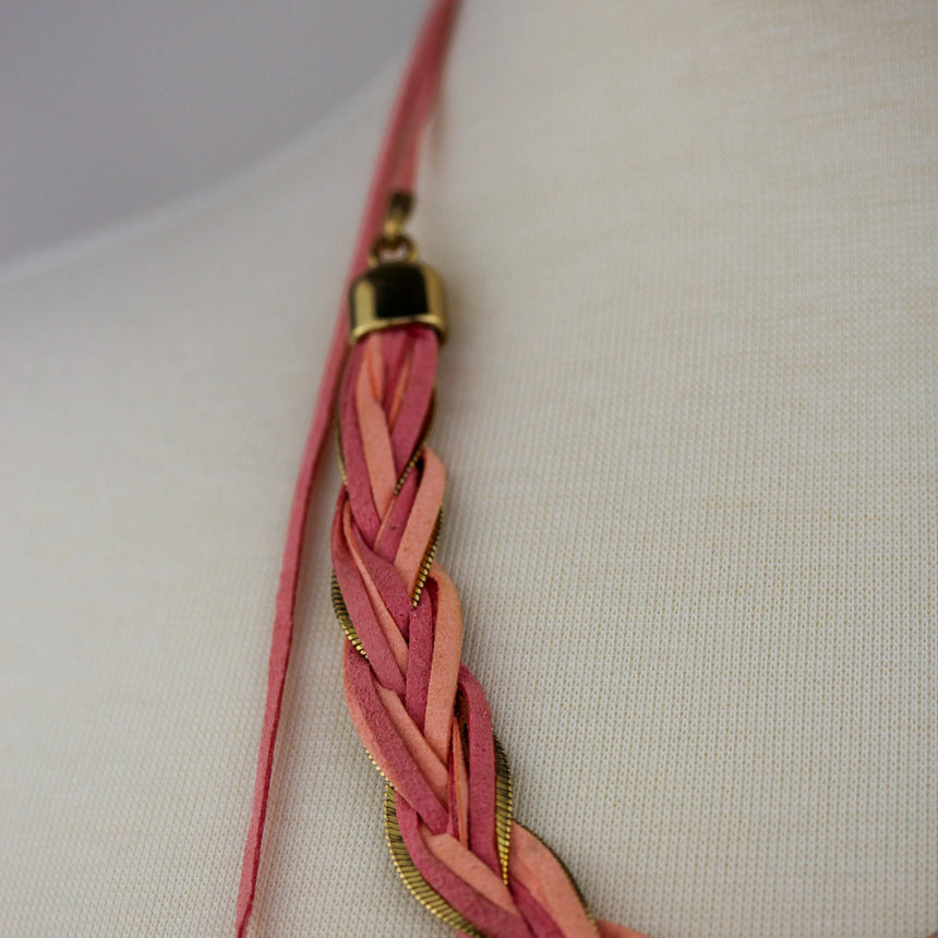 Braided Suede Lariat Necklace — Gold-Tone Chain, Pink Cord Ties, angled detail of a gold end cap and tie cord