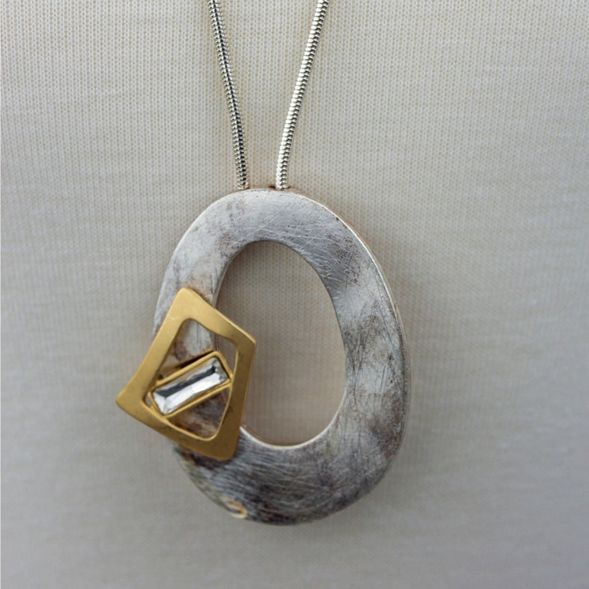 Organic Oval Pendant Necklace — Silver-Tone Chain, Crystal, close-up of the oval pendant and gold-tone accent
