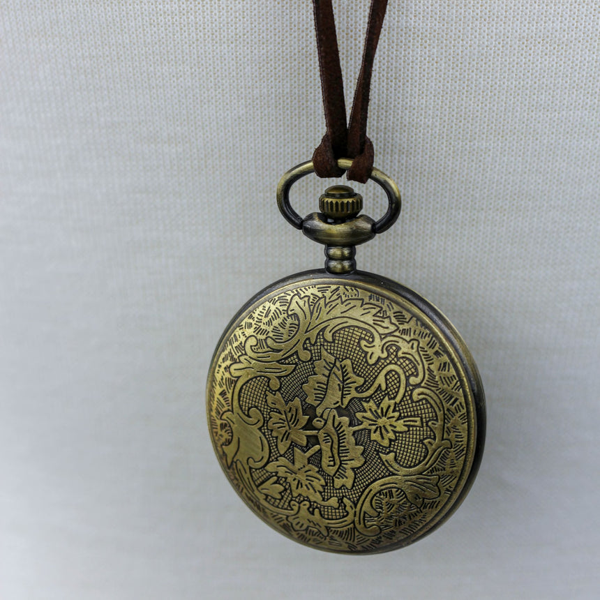 Pocket Watch Necklace — Bronze-Tone Alloy, Faux-Suede Cord, close-up of the etched filigree case back