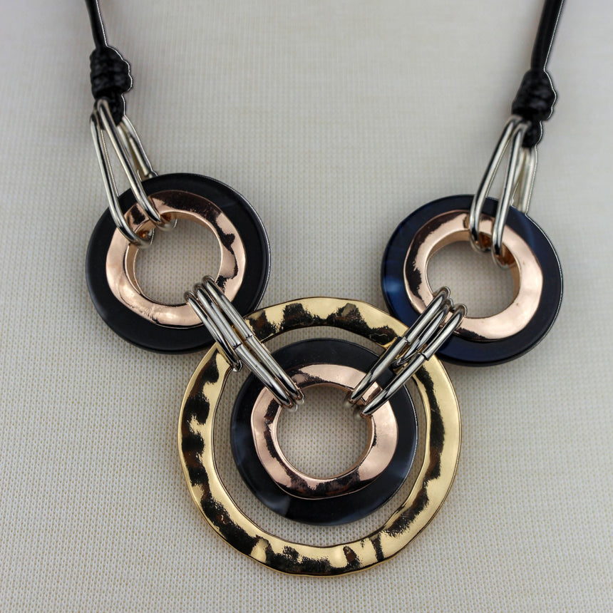 Interlocking Rings Necklace — Mixed-Tone Alloy, Black Cord, close view of the hammered gold-tone outer ring