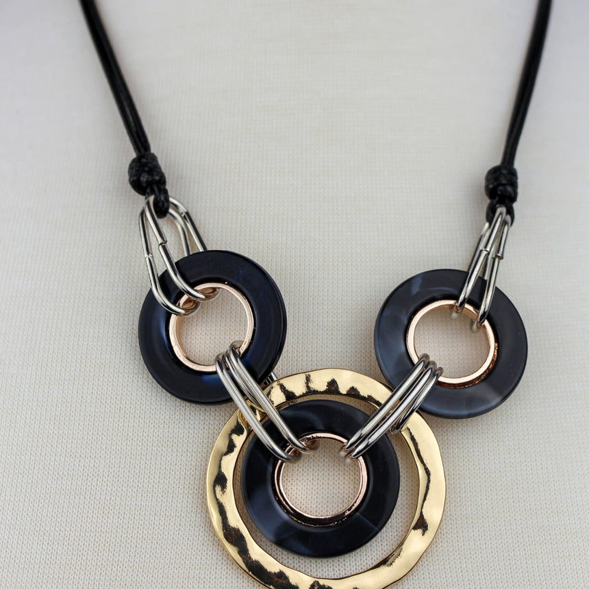 Interlocking Rings Necklace — Mixed-Tone Alloy, Black Cord, detail of the marbled black rings and silver-tone links