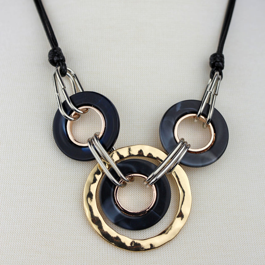Interlocking Rings Necklace — Mixed-Tone Alloy, Black Cord, close-up of the interlocked ring clusters