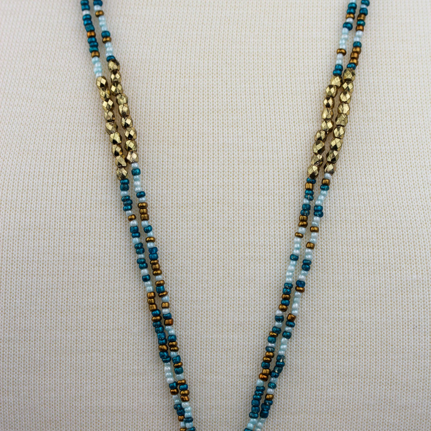 Boho Seed Bead Necklace — Rust Tassel Fringe, Antiqued Alloy, close-up of the teal and gold bead strands