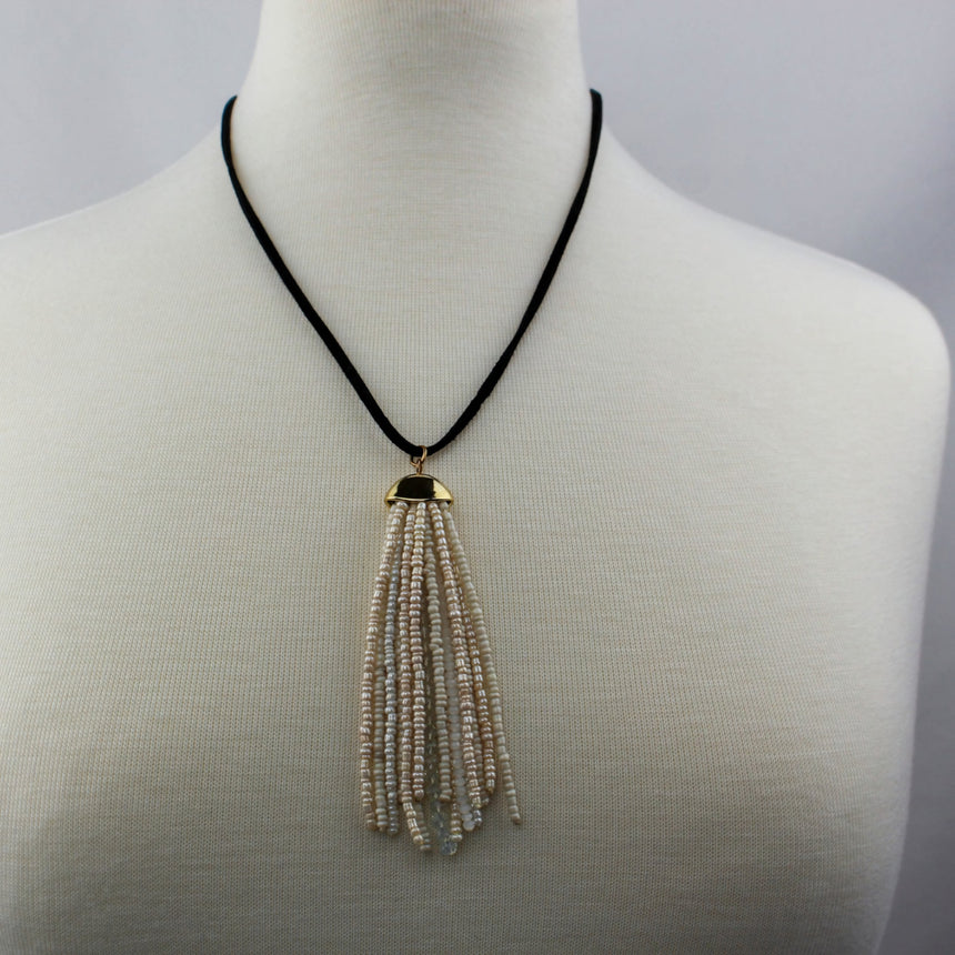 Cream Seed-Bead Tassel Necklace — Glass Beads, Faux Suede, full necklace with tassel pendant on mannequin