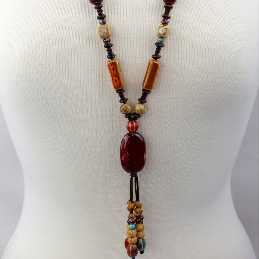 Boho Y Necklace — Red Oval Focal, Mixed Beads on Brown Cord, detail of the tube beads and focal on the cord
