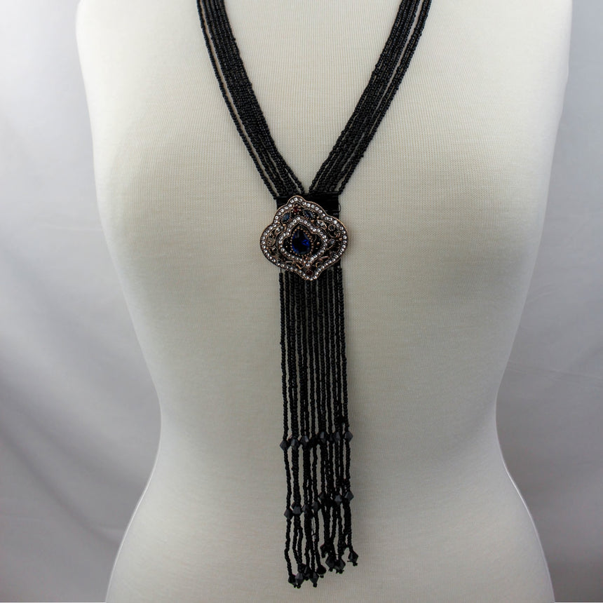 Black Fringe Y-Necklace — Seed Beads, Crystal Medallion, full multi-strand necklace with fringe on mannequin