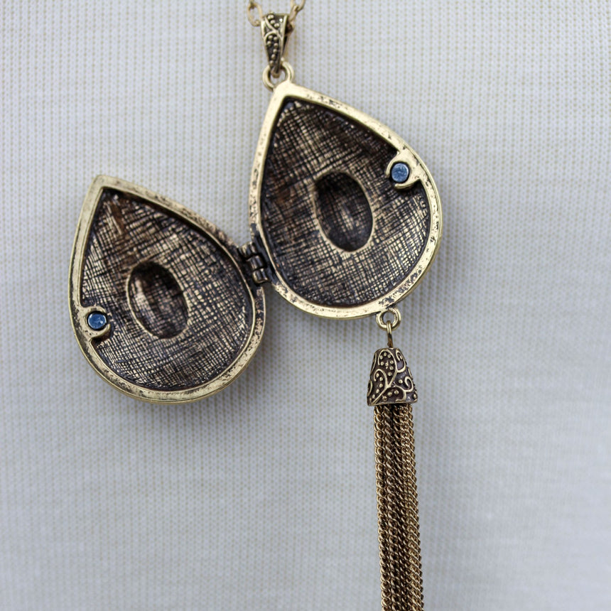 Teardrop Filigree Locket Necklace — Gold-Tone Alloy, Tassel, locket shown open with patterned interior recesses