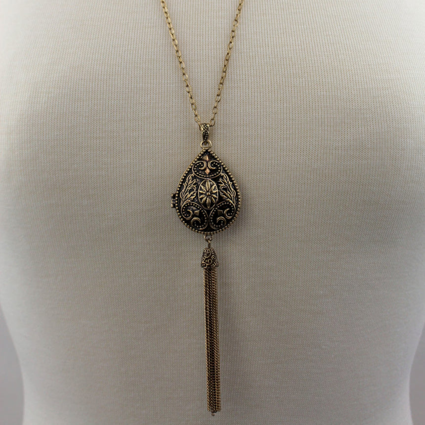 Teardrop Filigree Locket Necklace — Gold-Tone Alloy, Tassel, full-length view worn on a mannequin with chain tassel