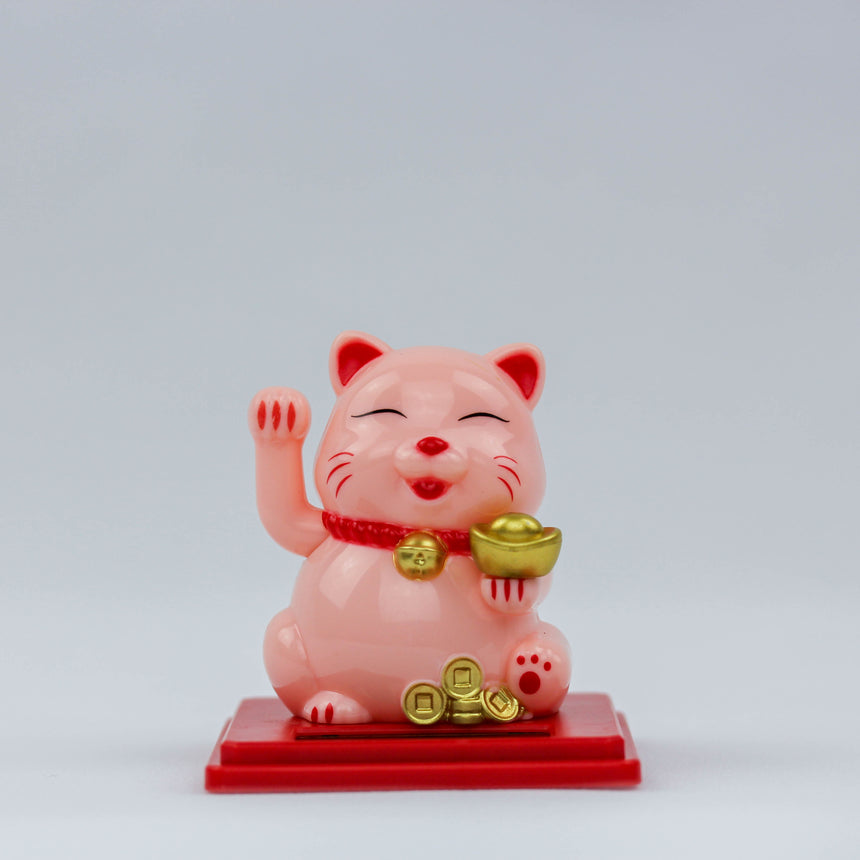 Solar Waving Fortune Cat with Gold Ingot, pink front view waving one paw, ingot in the other, coins at its feet on a red base