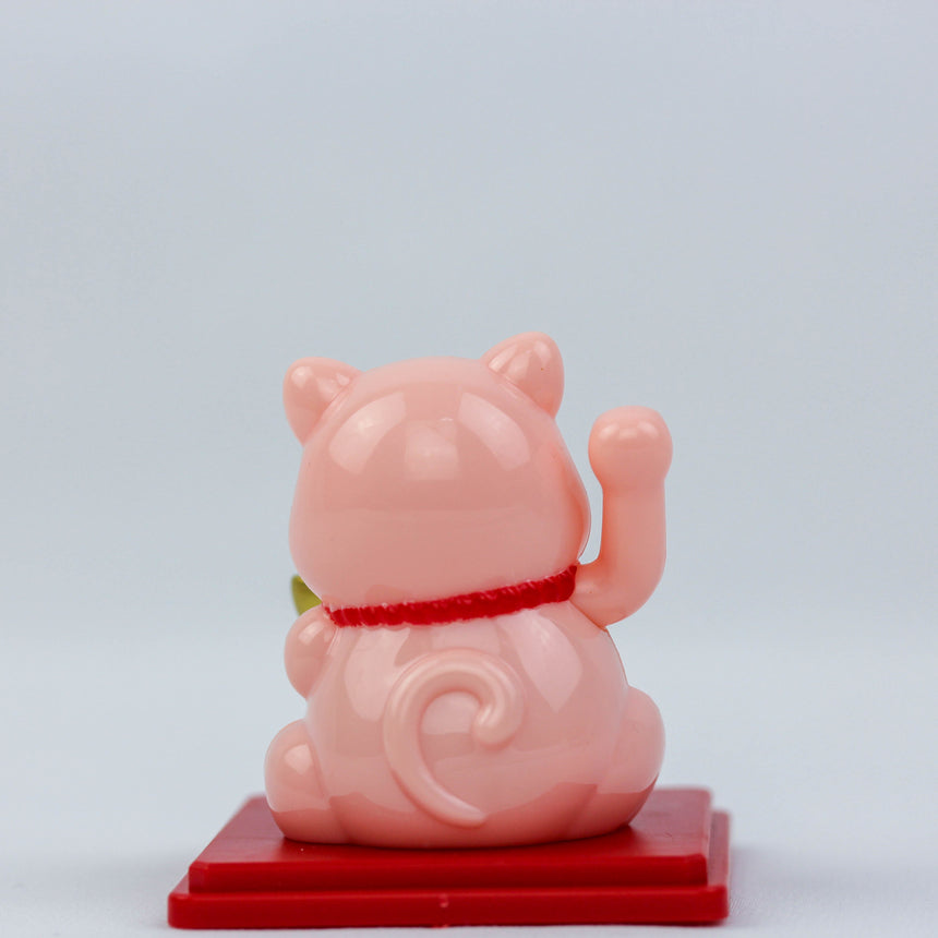Solar Waving Fortune Cat with Gold Ingot, pink back view showing curled tail, raised paw, and red collar on a red base