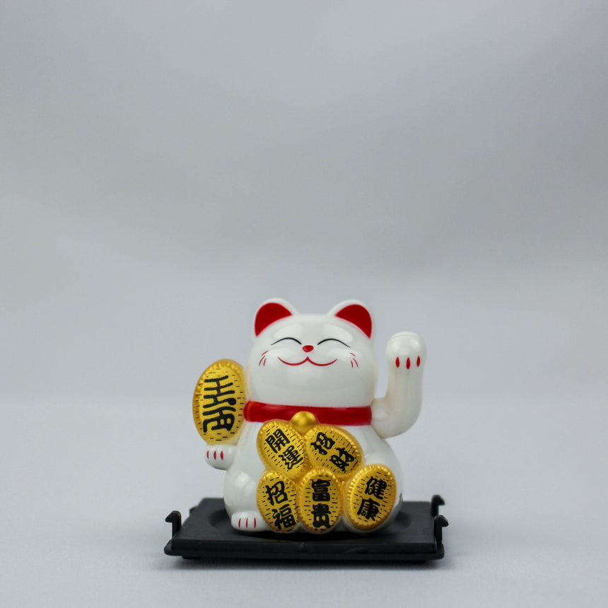 Solar Fortune Cat with Koban Coin and Fan, white front view holding a kanji koban coin, fanned coins at its feet