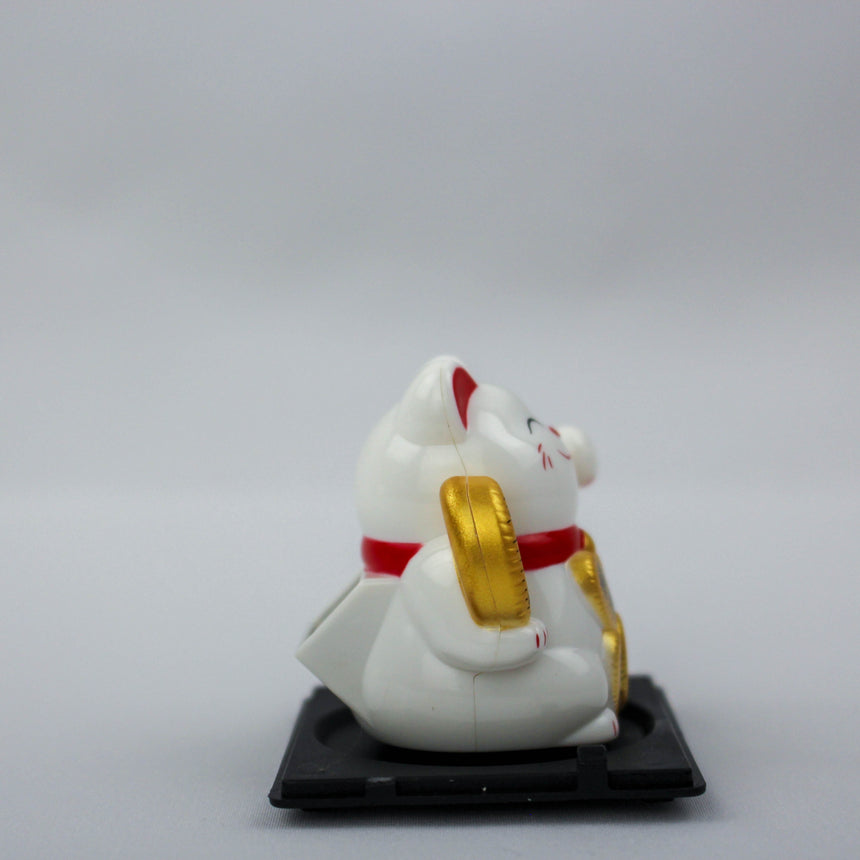 Solar Fortune Cat with Koban Coin and Fan, white rear three-quarter view with the gold coin fan at its side