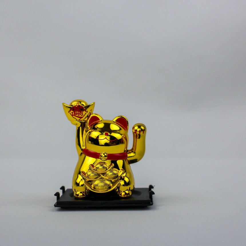 Solar Fortune Cat with Raised Ingot, gold front view, metallic finish, ingot with red seal held high, red collar