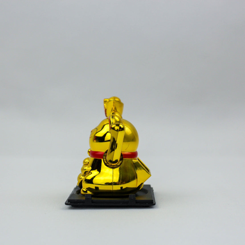 Solar Fortune Cat with Raised Ingot, gold side profile facing left with mirror shine, on a flat black tray