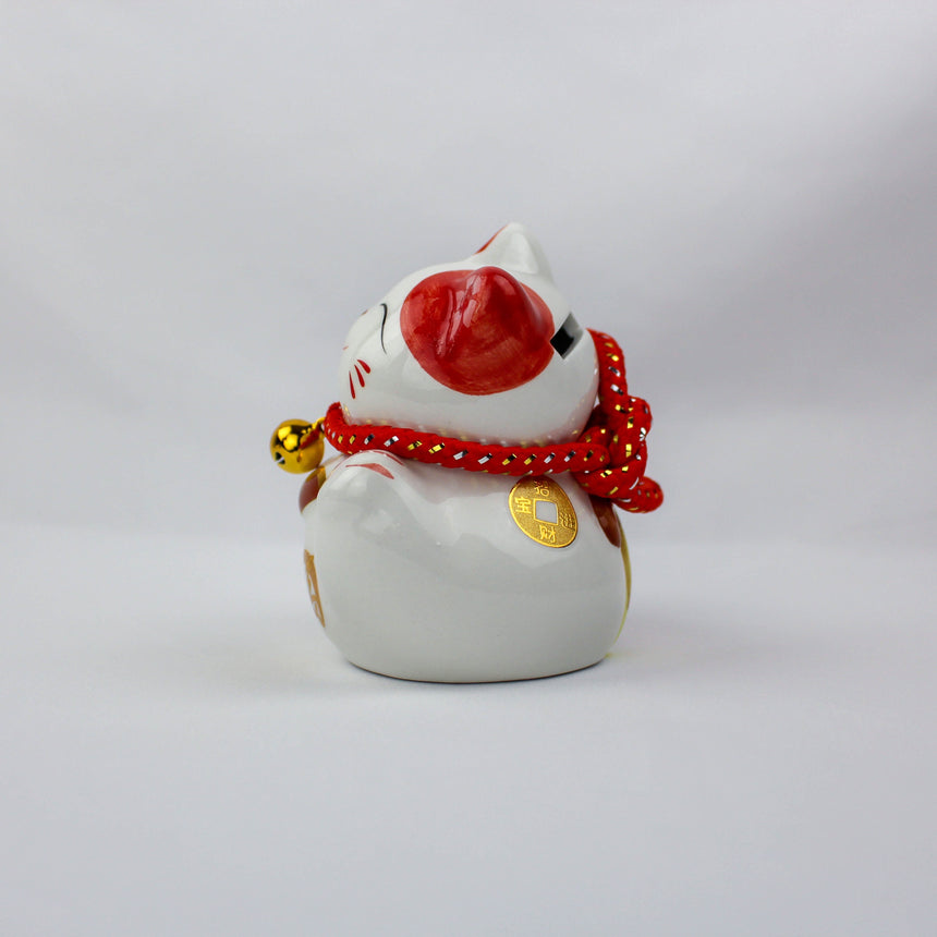 Da Ji Da Li Ceramic Lucky Cat Coin Bank, side rear view showing the red patch on its head and braided red collar