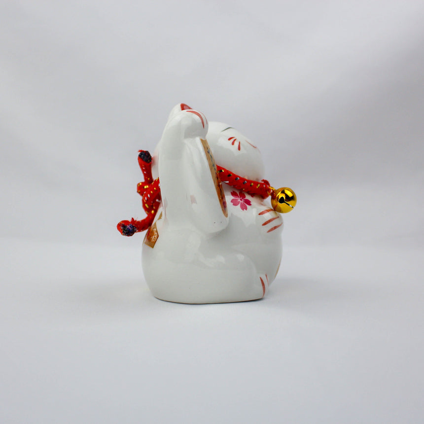 Da Ji Da Li Ceramic Lucky Cat Coin Bank, left side profile with gold bell, painted whiskers, and blossom accents