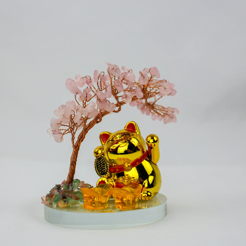 Solar Fortune Cat with Rose Quartz Gem Tree, gold cat waving beneath the pink crystal tree, amber ingots on the glass base