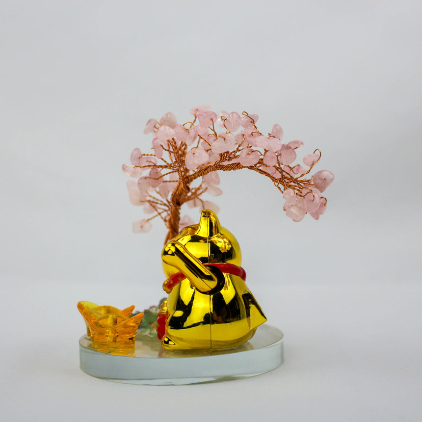 Solar Fortune Cat with Rose Quartz Gem Tree, back view of the gold cat under the arched tree, amber ingot at its side